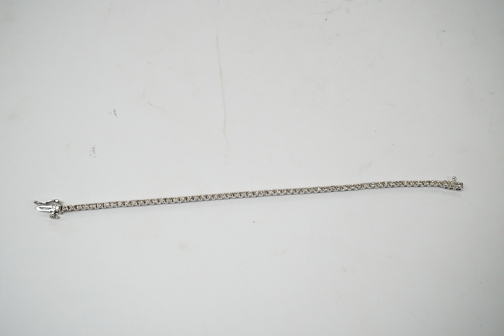 A modern 9ct white metal and diamond set tennis bracelet, with a total diamond weight of 1.50ct, 17.3cm, gross weight 6.6 grams. Condition - good